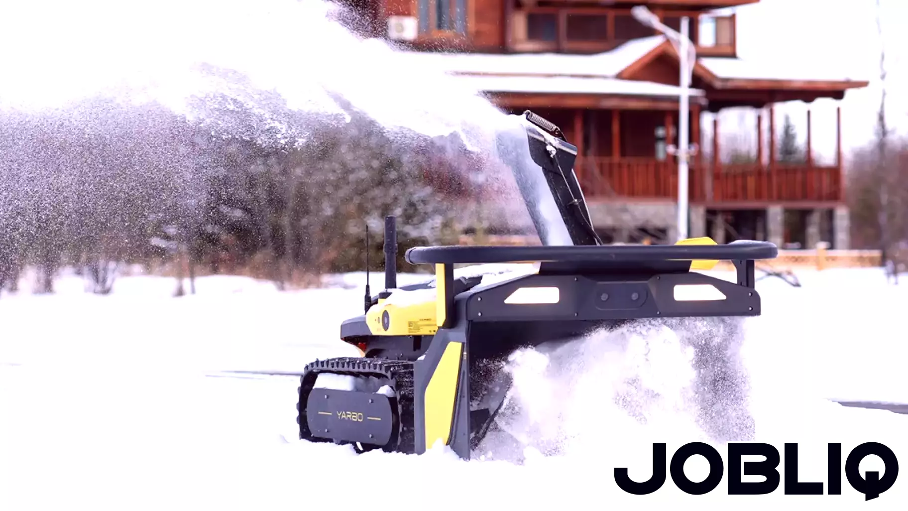 Man clears driveway with autonomous snow blower during storm